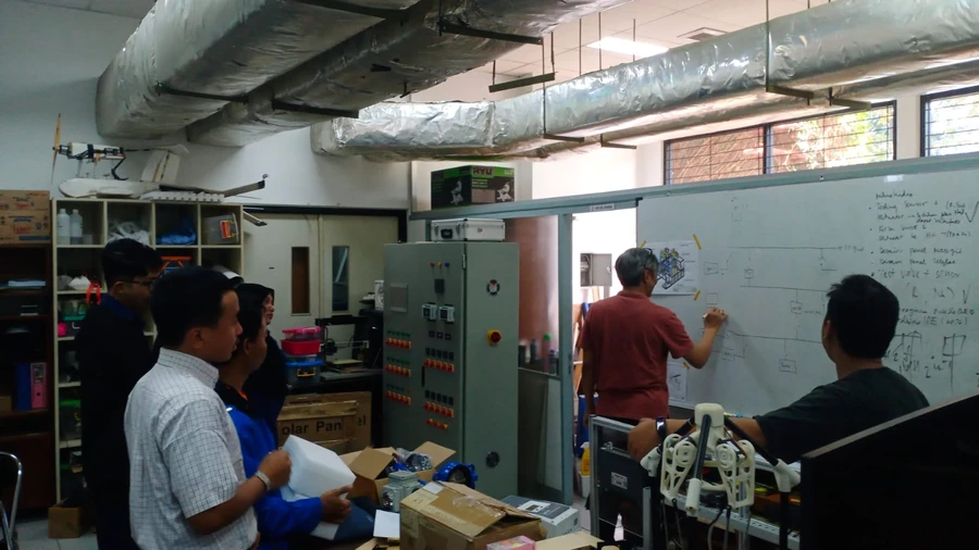 Design discussion for the micro-hydro panel at the whiteboard (July 2024)