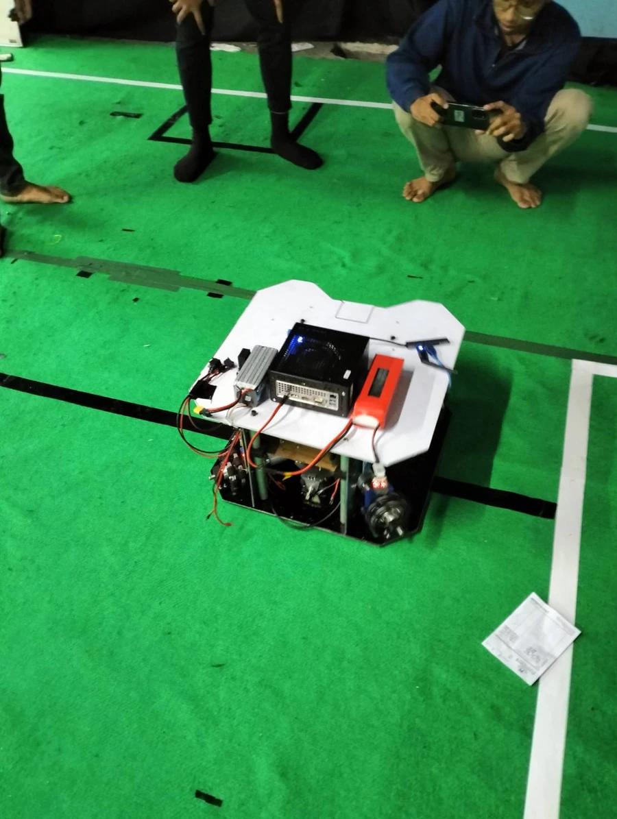 The robot on the field with its compute unit and battery on top
