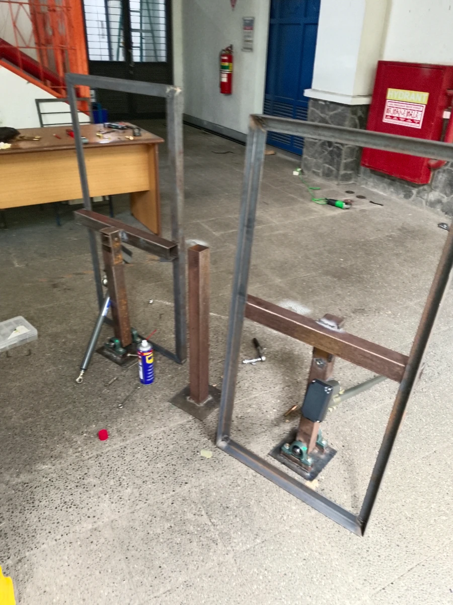 Steel frames with pillow-block bearings and a linear actuator during assembly